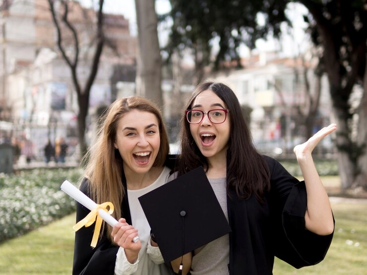 Two MBA girl students holding degree in hand on convocation